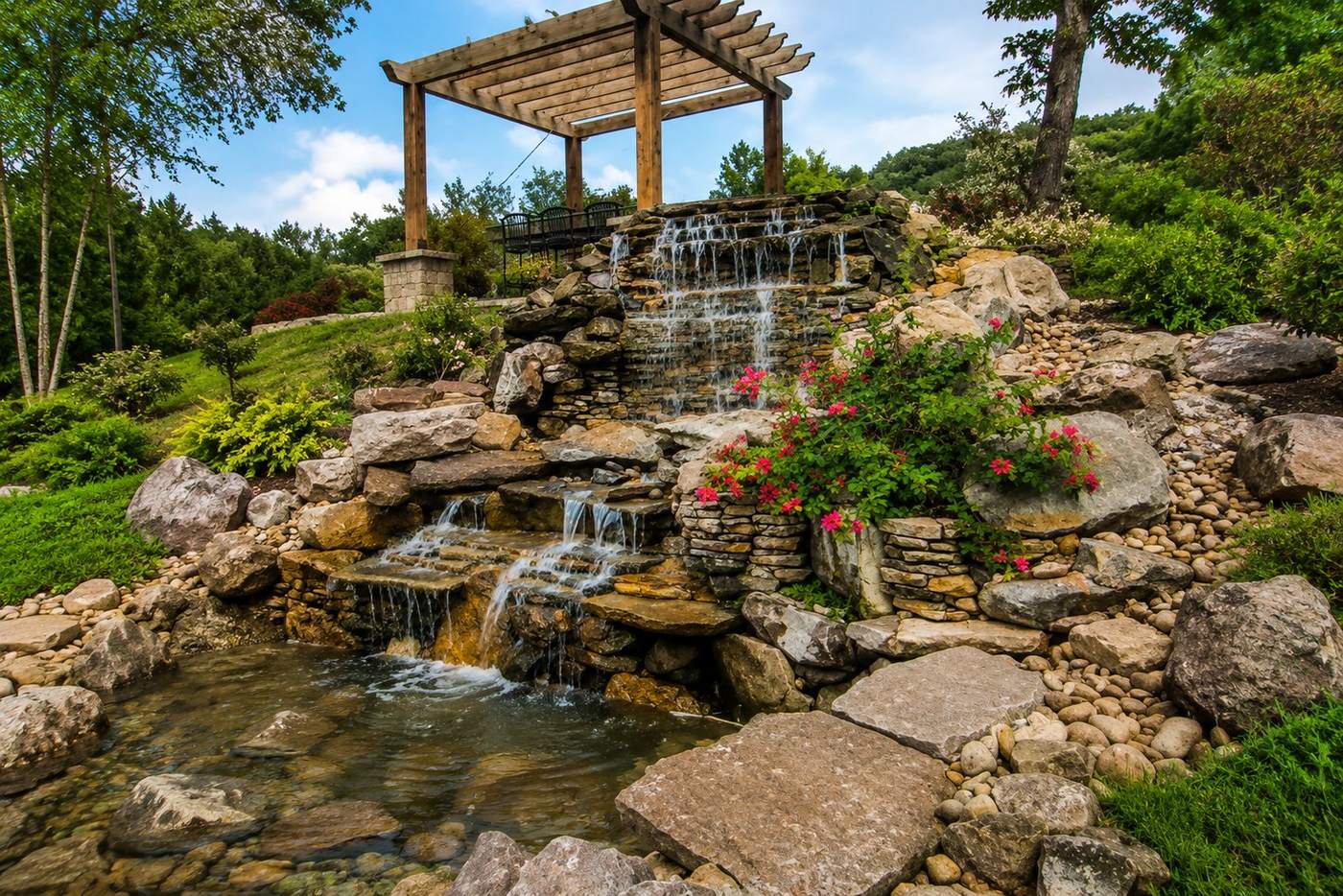 Custom stacked-stone waterfall with pergola, Luxury Stonework TN signature project