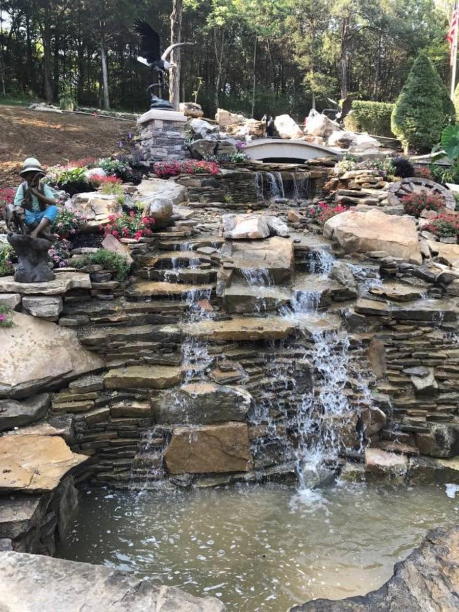 Multi-tier waterfall with stone bridge