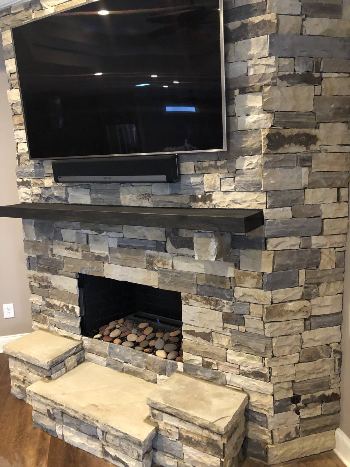 Indoor stacked stone fireplace