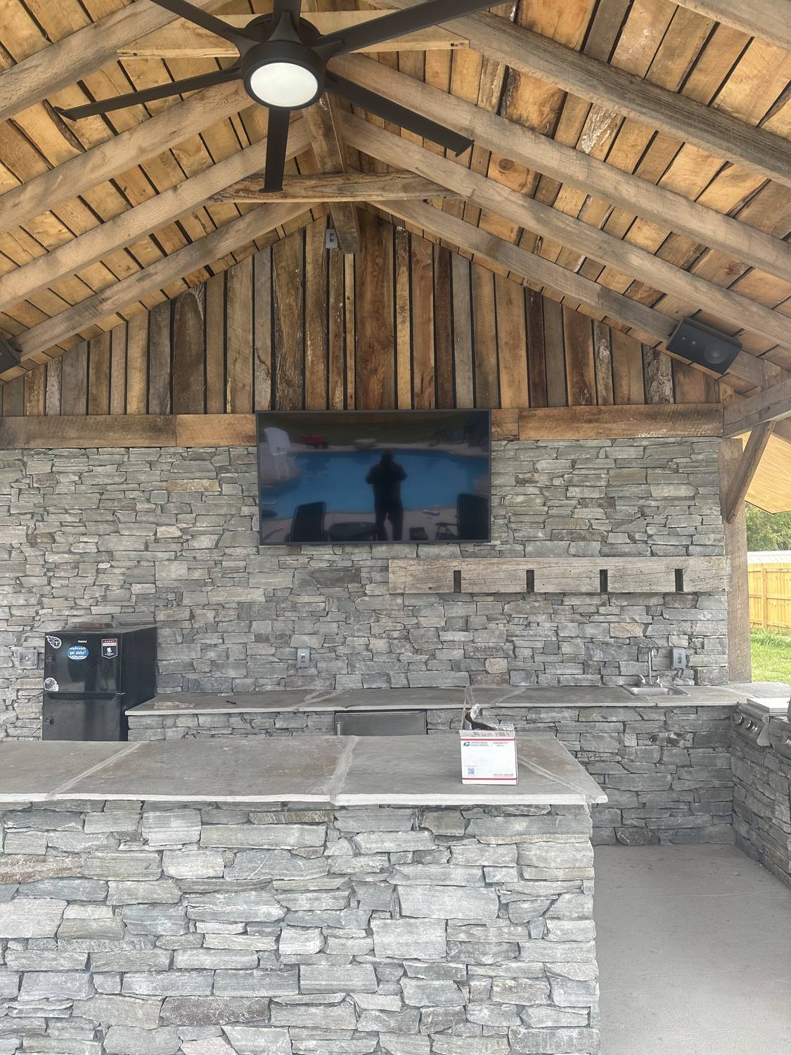 Outdoor stone fireplace and grill living space