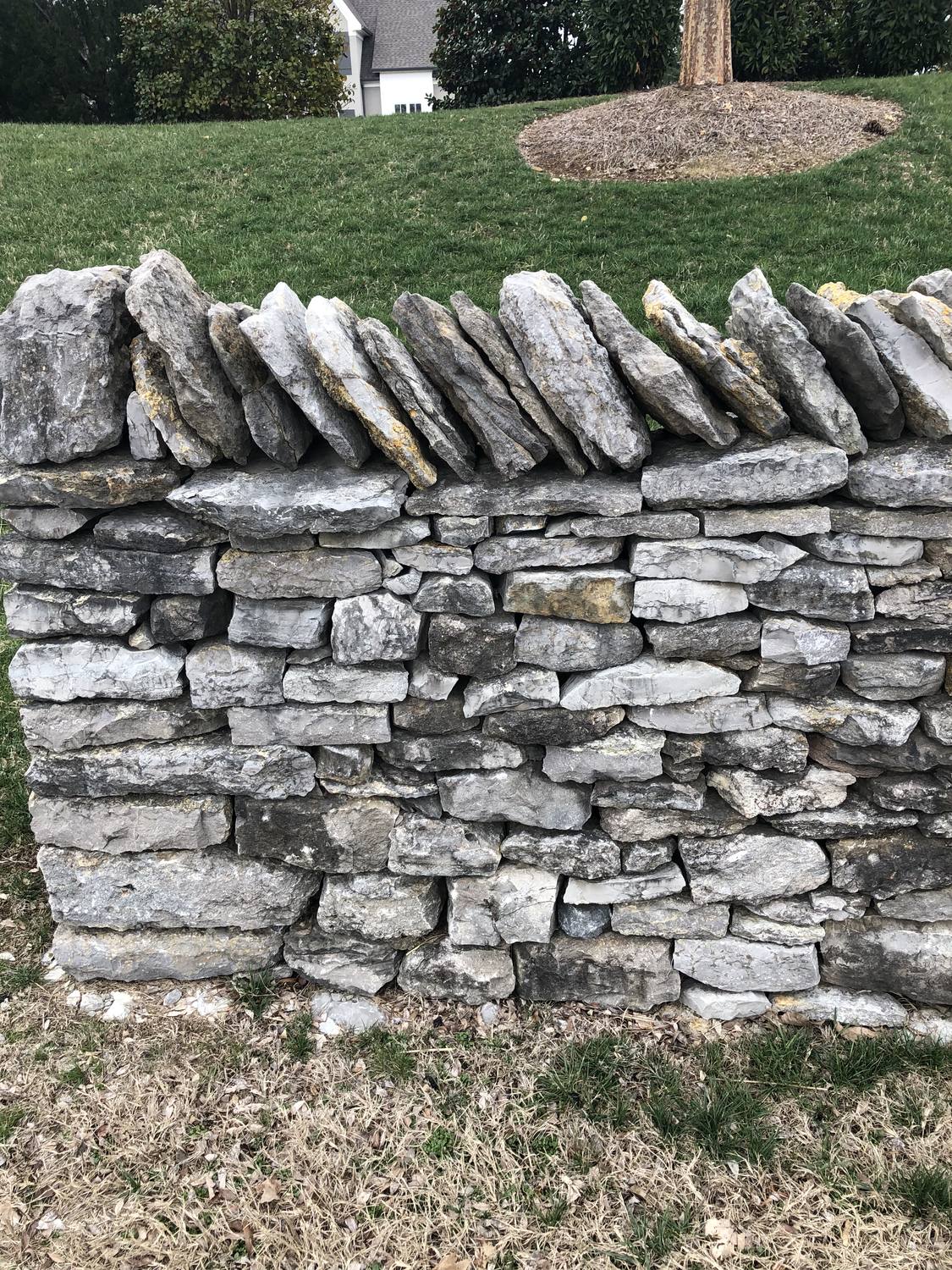 Dry-stacked natural stone retaining wall